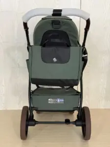Vista posteriore del passeggino con maniglione imbottito e borsa portaoggetti verde scuro